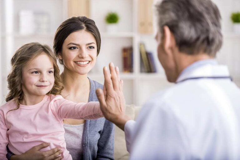 smiling mother and daughter at doctor's office