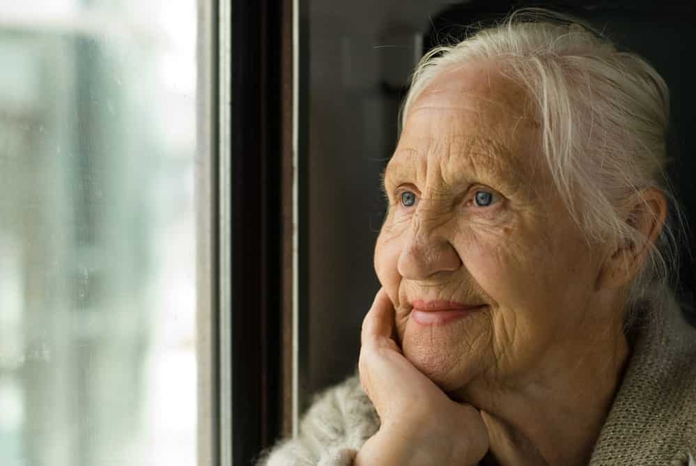 Senior woman looking out window