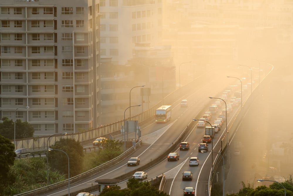 Air pollution in busy city, near highway and apartment buildings