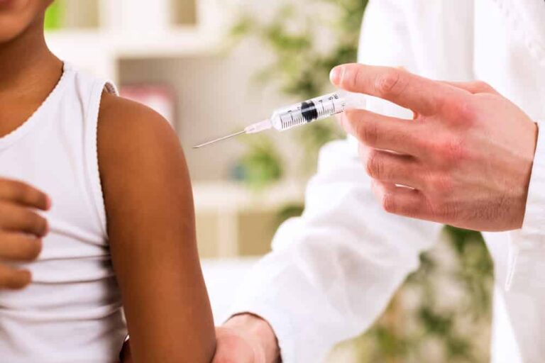 Close-up of medical professional administering vaccine in a child's arm