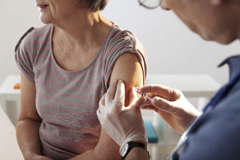 Senior woman being vaccinated