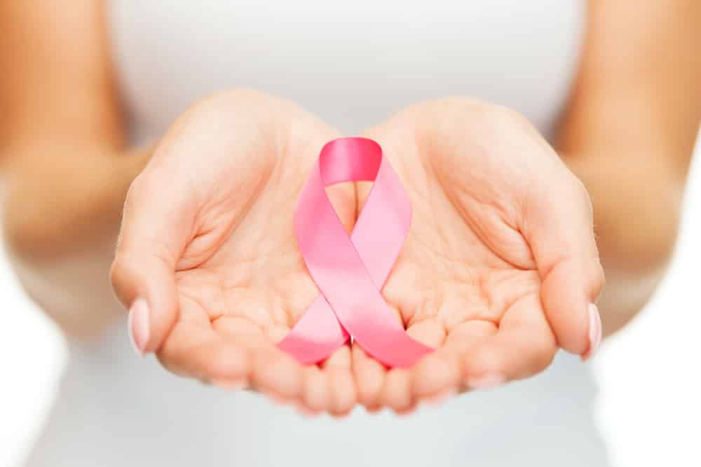 Hands holding breast cancer awareness pink ribbon