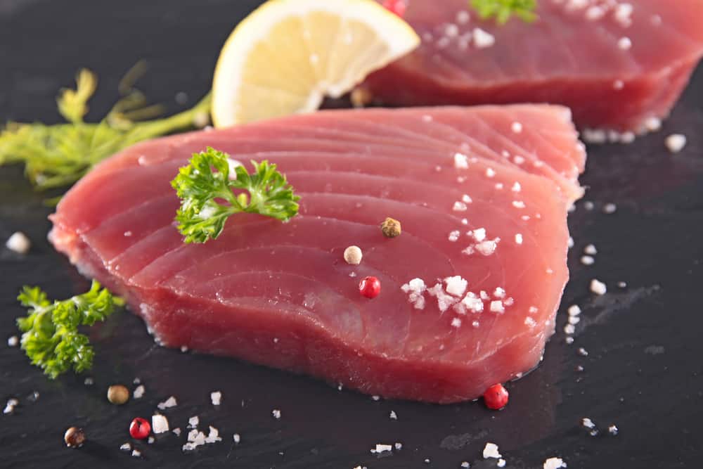 Raw tuna fish fillet spirnkled with salt and parsley