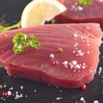 Raw tuna fish fillet spirnkled with salt and parsley