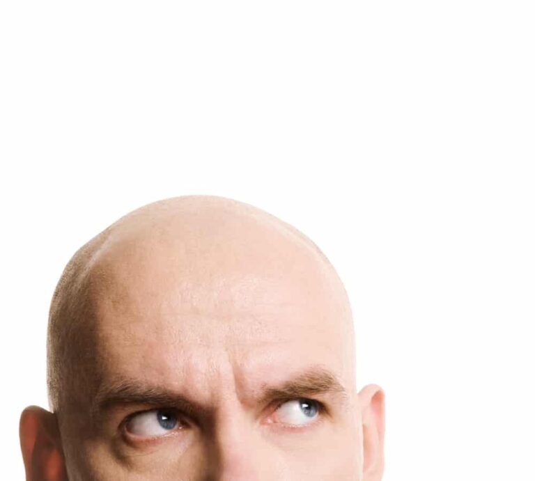 Cropped image of bald man looking up on white background
