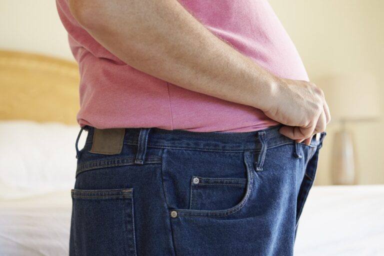 Close-up of overweight man waist
