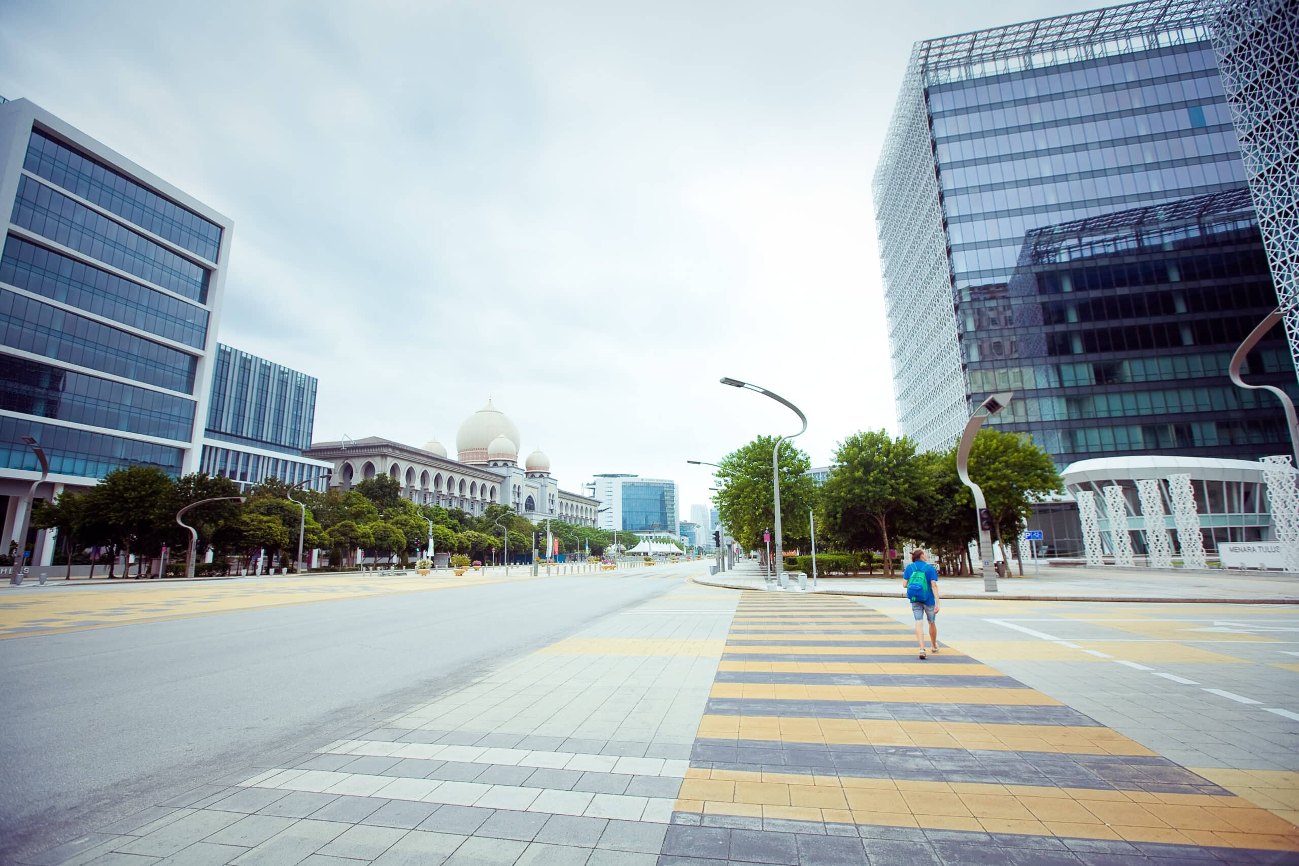 Lone figure walking in empty city