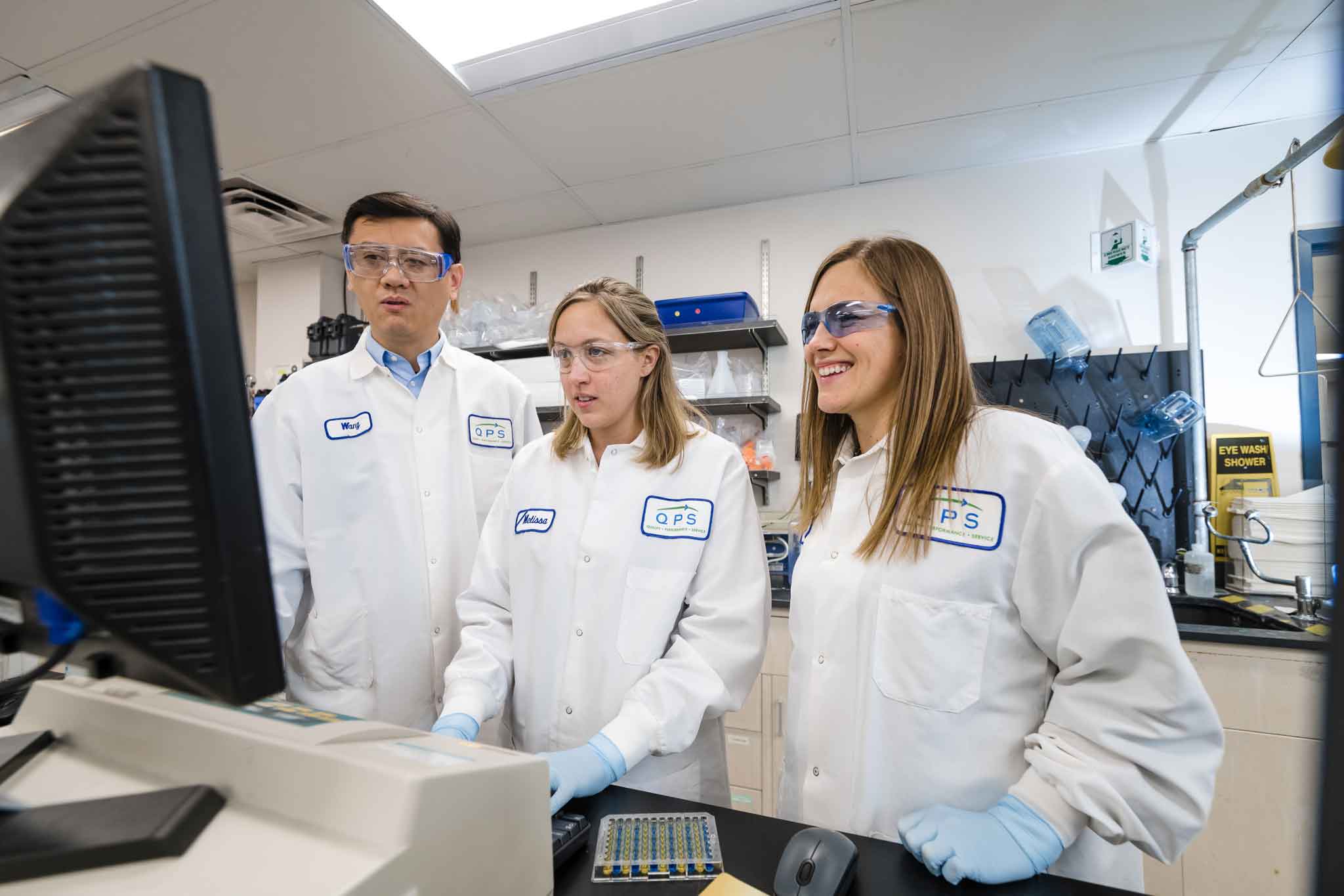 QPS Staff in Lab gown