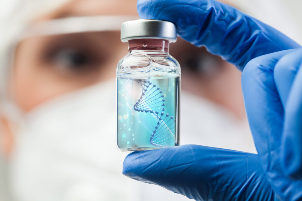 UK lab scientist biotechnologist holding glass ampoule vial with DNA strand