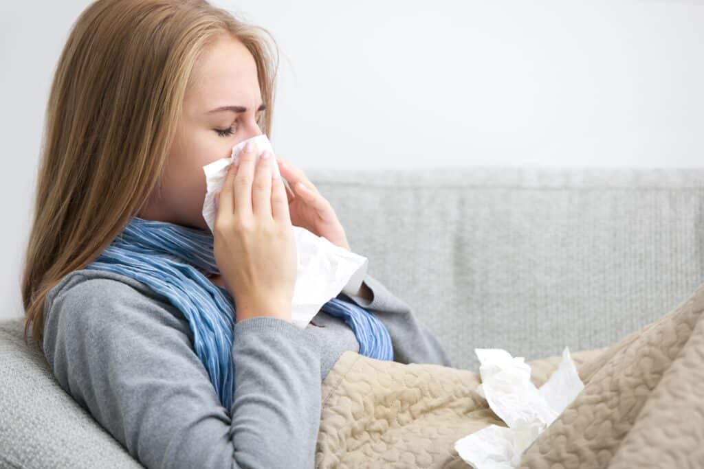 Young-woman-with-runny-nose-flu