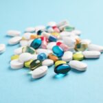 Pile of pills on blue background