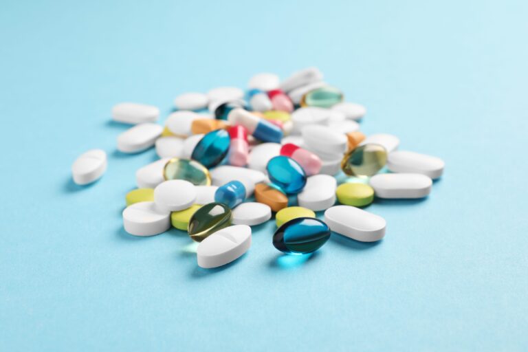 Pile of pills on blue background