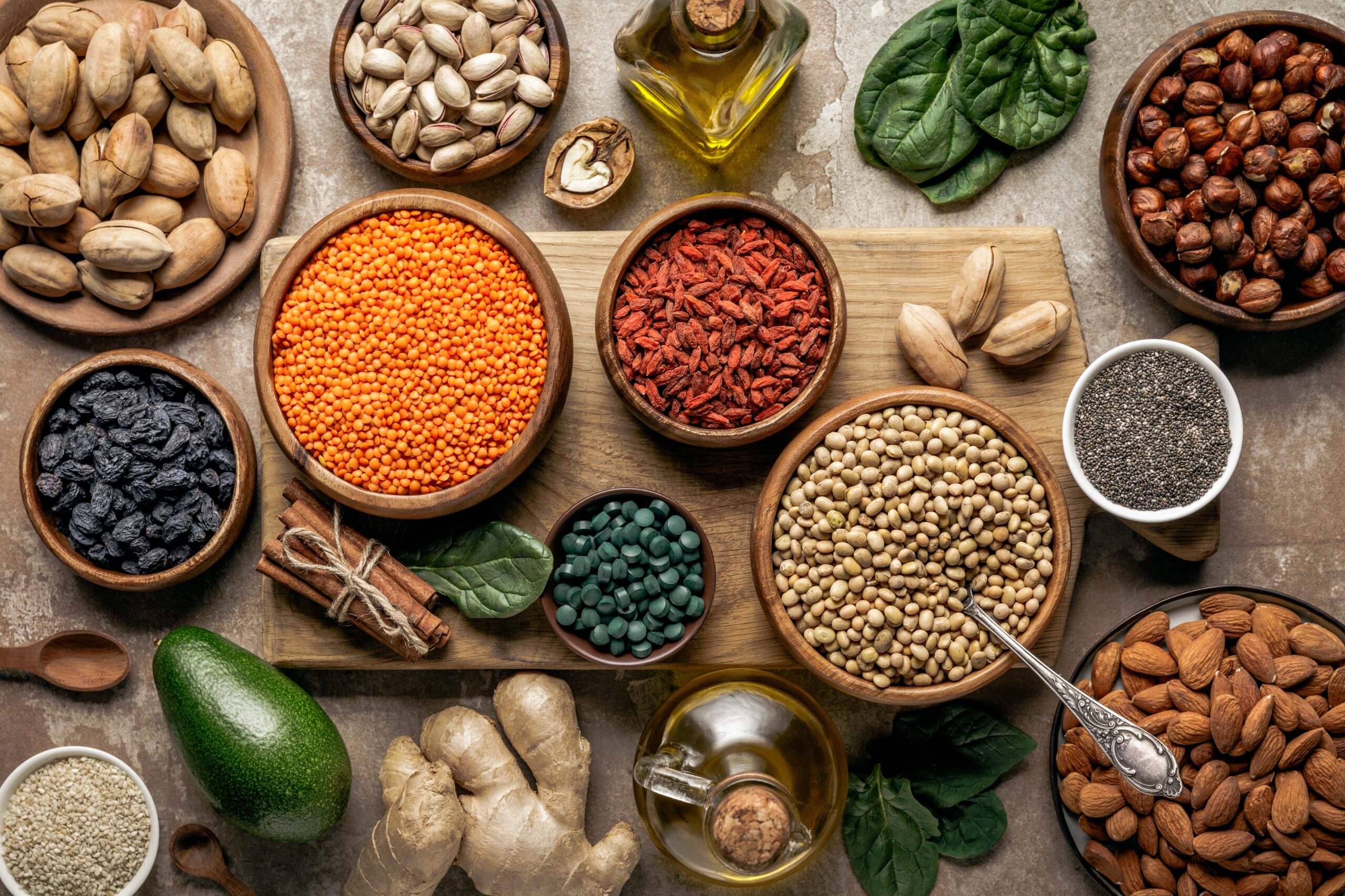 Healthy array of food, nuts, legumes, ginger, spinach, etc