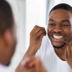 Man flossing his teeth