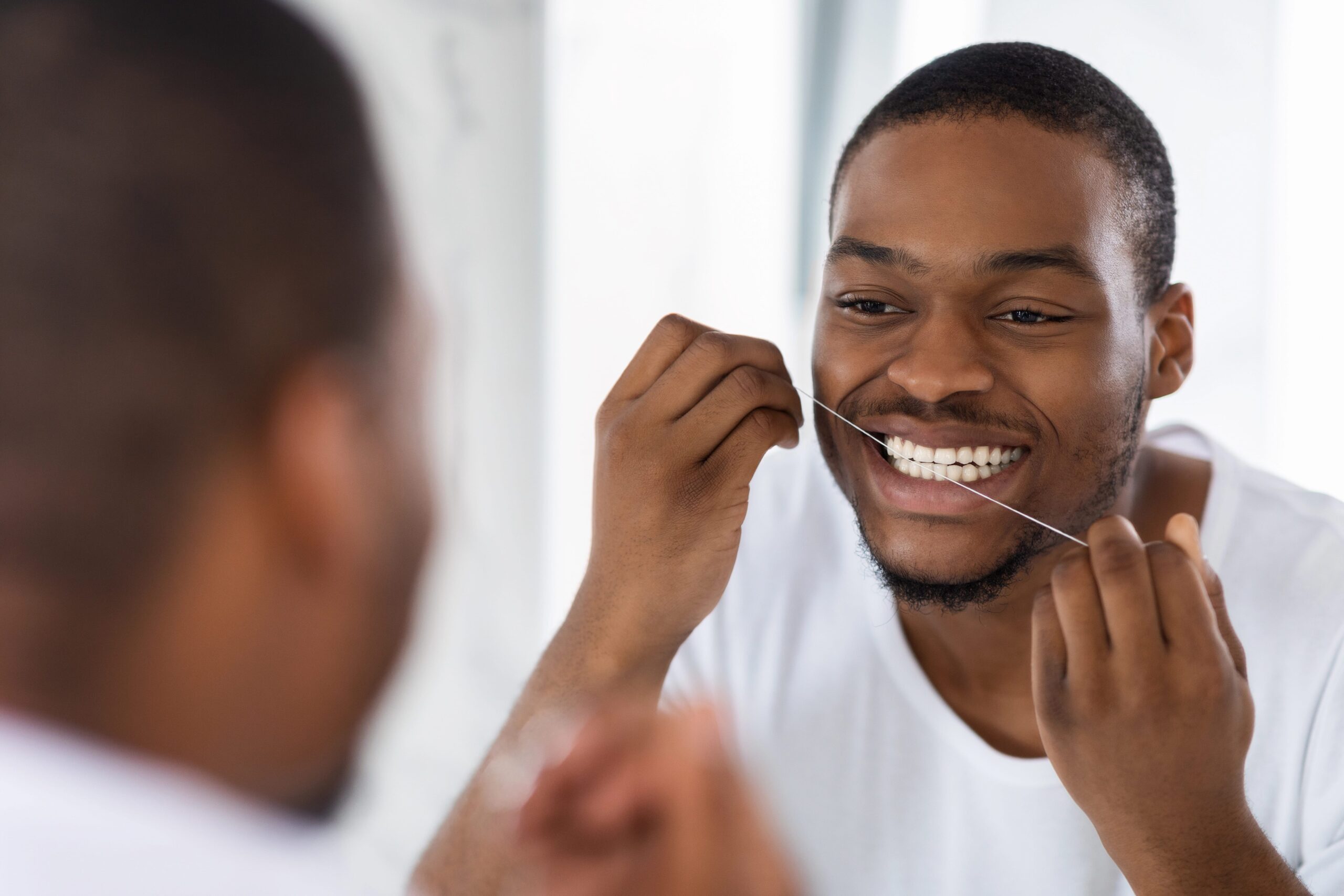 Man flossing his teeth
