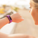 Woman checking fitness and health tracking wearable device
