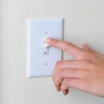 Hand flipping a light switch