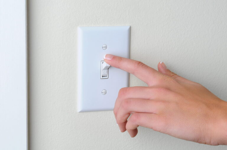 Hand flipping a light switch