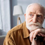Senior man resting his head on his hands