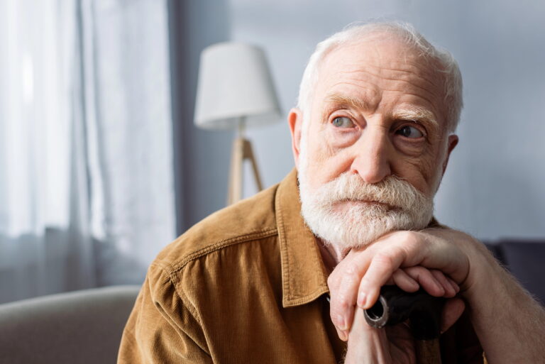 Senior man resting his head on his hands