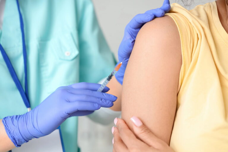 Close-up of female patient receiving vaccination
