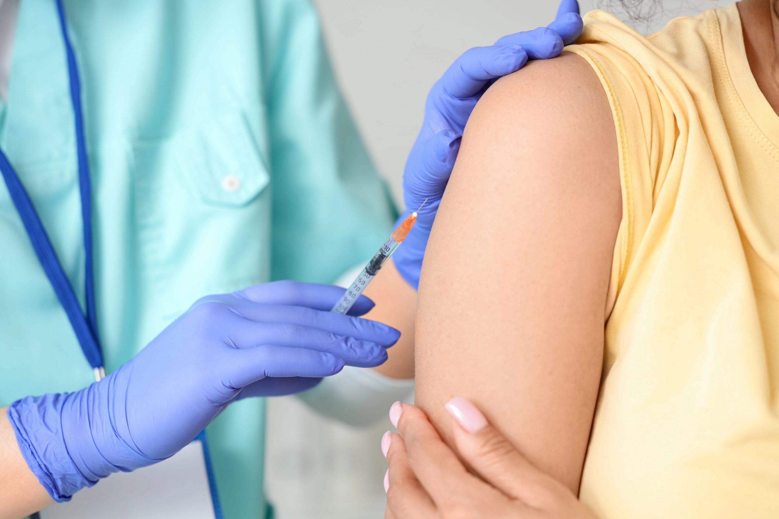 Close-up of female patient receiving vaccination