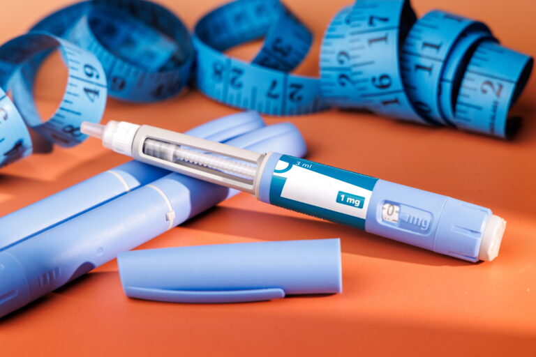 GLP-1 Injection Pen Beside Measuring Tape
