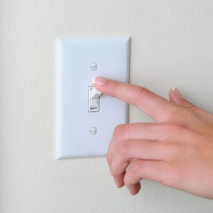 Hand flipping a light switch