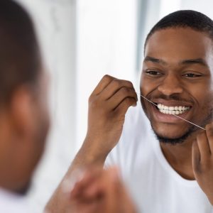 Man flossing his teeth