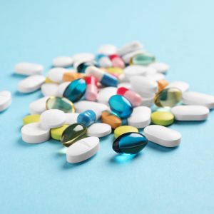 Pile of pills on blue background