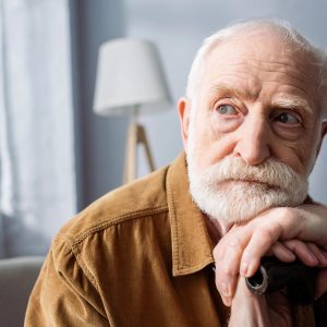 Senior man resting his head on his hands