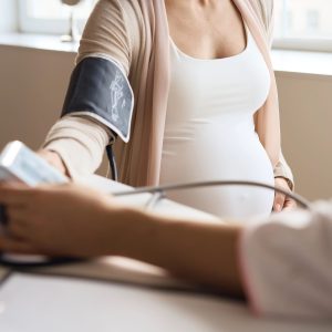 doctor measuring blood pressure of pregnant patient (1)